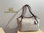 Coach Canvas Tote With Snap Button Design – A Versatile And Fashionable Handbag.