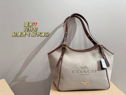 Coach Canvas Tote With Snap Button Design – A Versatile And Fashionable Handbag.
