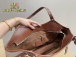 Coach Canvas Tote With Snap Button Design – A Versatile And Fashionable Handbag. - Image 9
