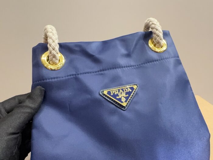 Prada Nylon Bucket Bag Spacious And Ultra-Lightweight For Commuting Metal Rings On Both Sides For Attaching Charms - Image 9